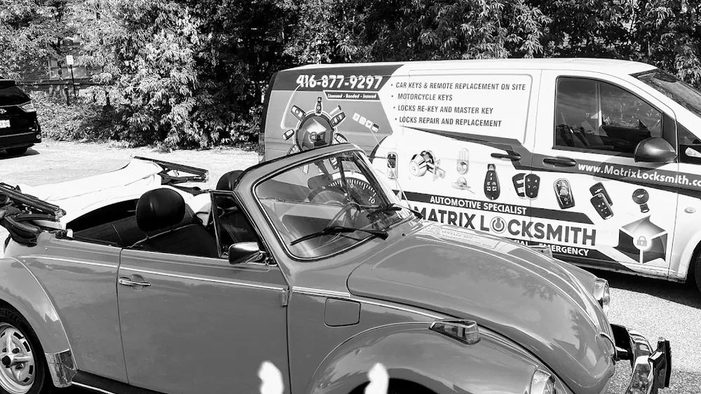 Car keys cut by Matrix Locksmith beside the customer’s car and the Matrix automotive locksmith van
