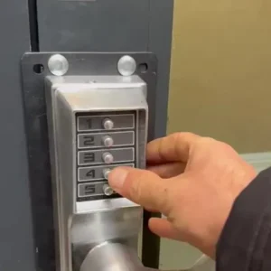 Push-button keyless lock on a commercial warehouse door.