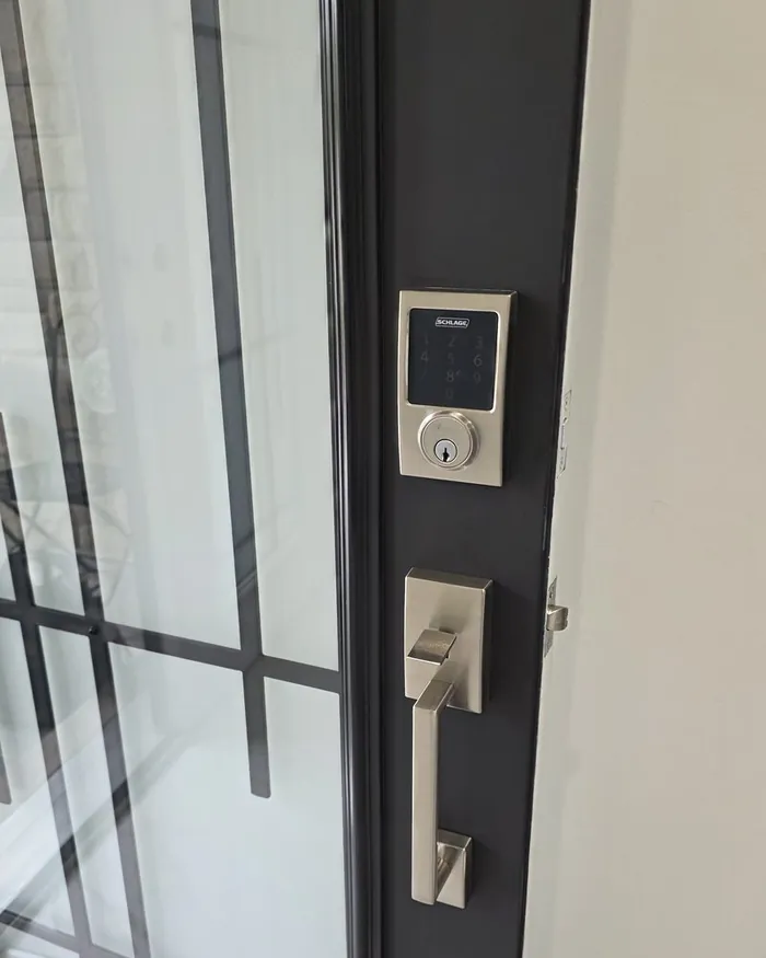 Finished keypad deadbolt and handle set on a black front door