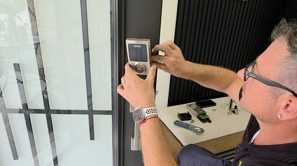Matrix locksmith installing a smart keypad deadbolt on a front door